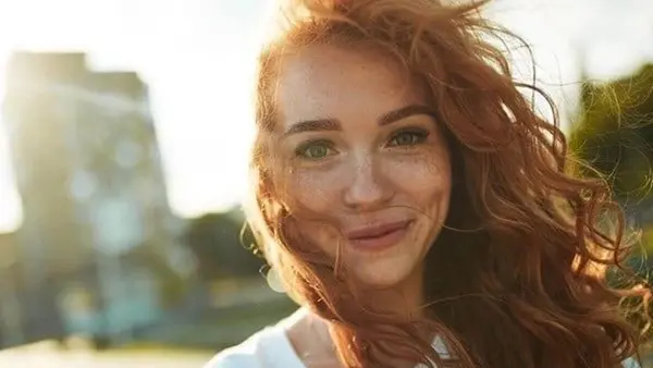 A woman with red hair and green eyes.