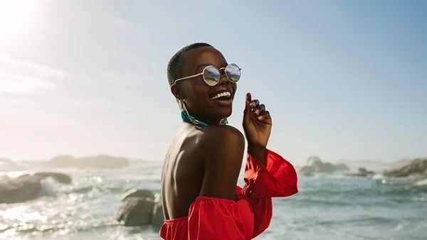 A woman in red shirt and white sunglasses