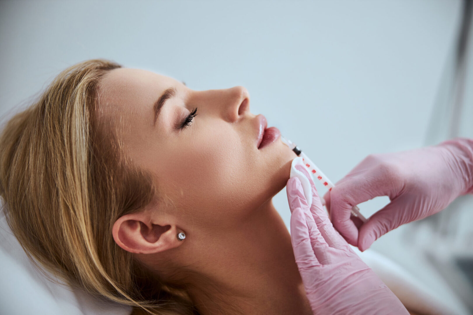 A woman getting her face waxed at the salon