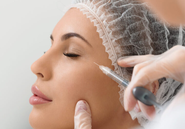 A woman getting her face waxed by an esthetician.