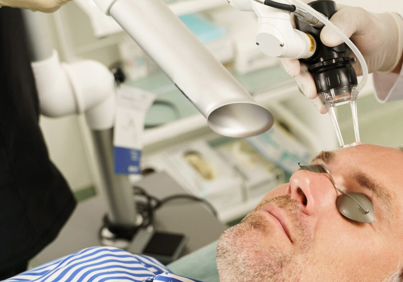 A man getting his eyes examined by an eye doctor.