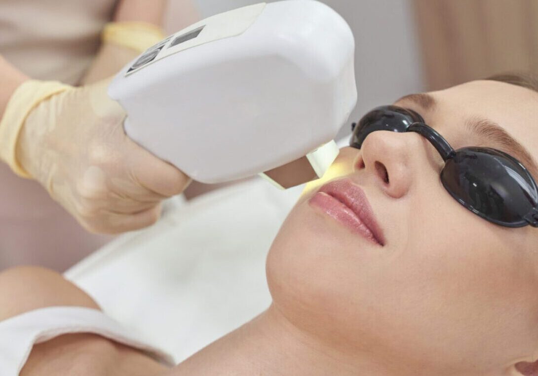 A woman getting her teeth cleaned by an esthetician.